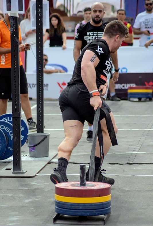 Farmer Strength Training: 6 Powerful Moves for Total Body Strength 4 strongman competitor pulling weighted sled