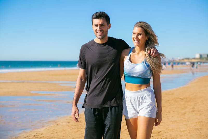 Why Is It So Hard to Lose Weight: Breaking Through the Challenges and Finding Solutions 5 fit man and woman walking along a beach