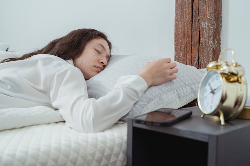 Why Is It So Hard to Lose Weight: Breaking Through the Challenges and Finding Solutions 3 to illustrate why is it so hard to lose weight this is an image of a woman getting important sleep