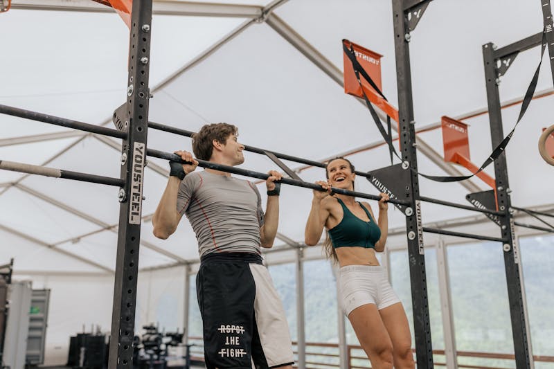 Quick Workouts for Unstoppable Strength: How to Create Your Own Routine That Works! 3 a couple smiling while doing pullups