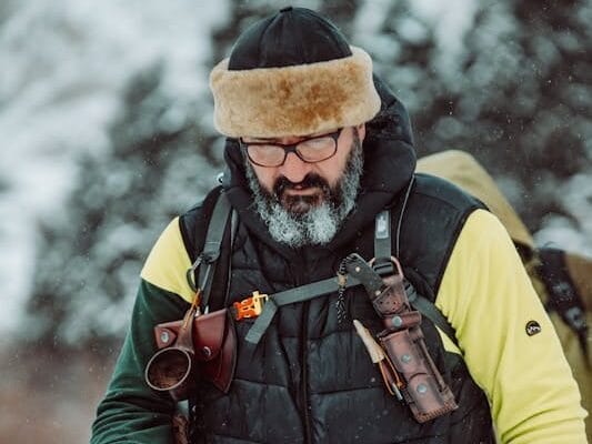 Survival Fitness: Master Your Life and Thrive when SHTF 3 man carrying backpack with survival equipment hiking through snow