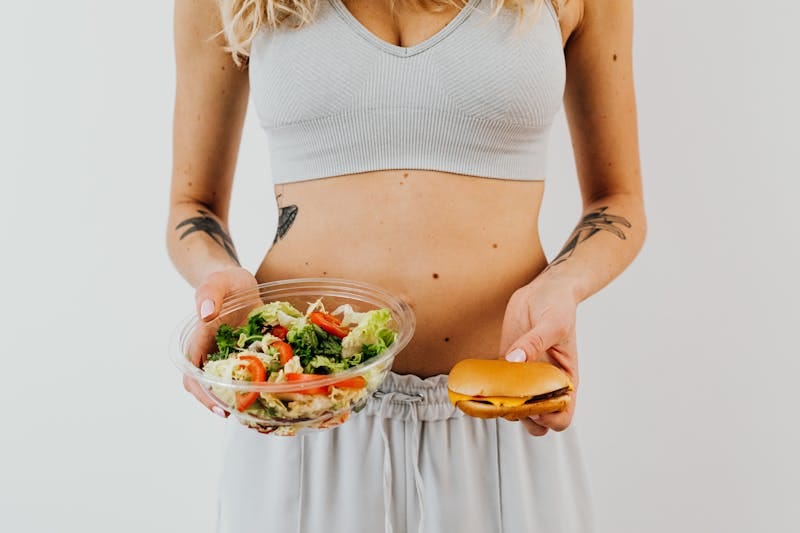 Can You Lose Weight Without Exercise? Discover Proven Strategies! 2 woman demonstrating healthy vs unhealthy food to address the question: can you lose weight without exercise