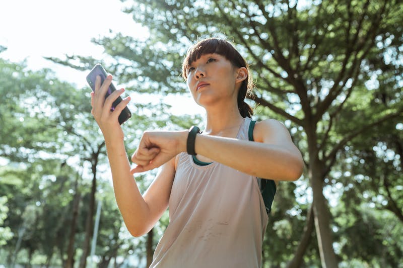 Quick Stats: How Can You Improve Cardiovascular Fitness? 2 how can you improve cardiovascular fitness demonstrated by woman taking pulse and looking at a health app