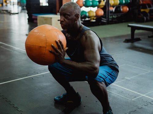 Micro Workouts: 7 Powerful Benefits for Fast Fitness Results 4 man doing squats holding a medicine ball