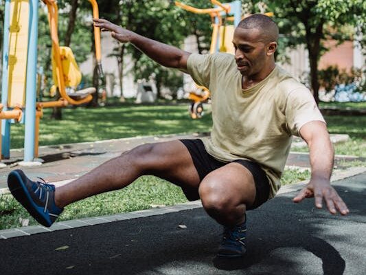 Full-Body Bodyweight Workout: A Dynamic 5 Step Plan 2 man doing pistol squats in a park