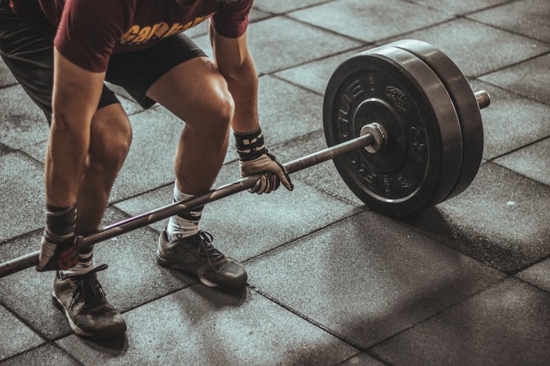 Quick Stats: How Can You Improve Cardiovascular Fitness? 5 man beginning deadlift with heavy barbell