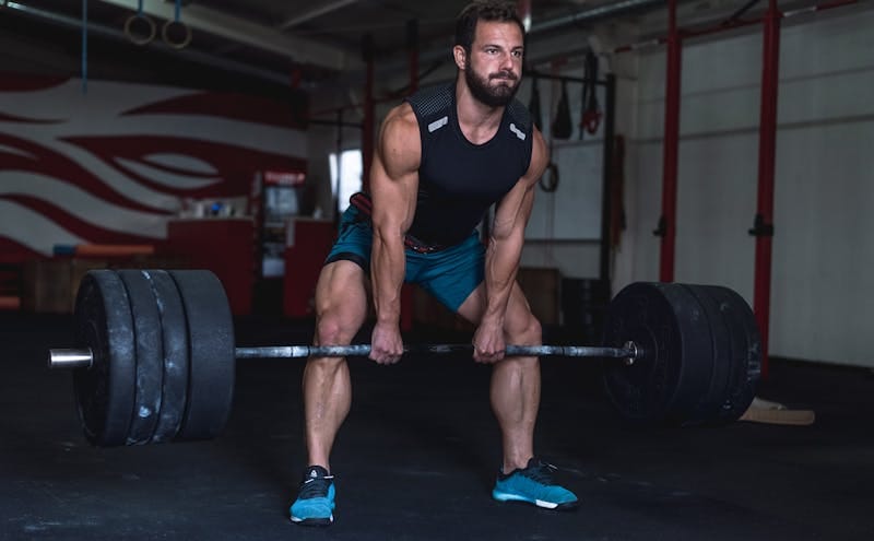 7 Powerful Functional Fitness Moves for Tough Times 9 man performing the deadlift with weighted barbell