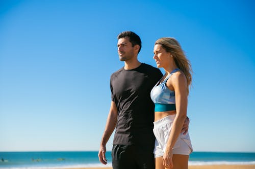 Minimalist Strength Training: 5 Myths Debunked 6 fit couple on beach with blue sky