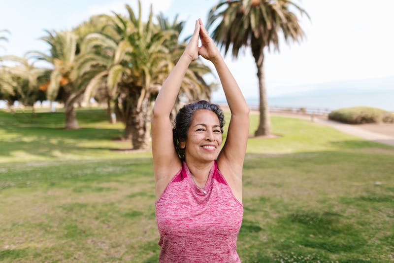 The Ultimate Calisthenics FAQ: Everything You Need to Know About Bodyweight Training 5 woman stretching doing a cool down in an ocean side park