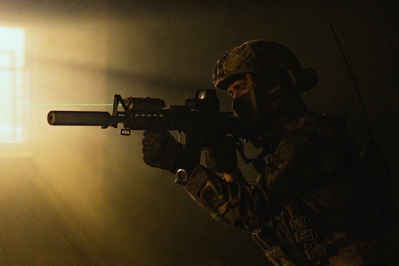 Functional Strength Through Calisthenics: Unlocking Your Full Potential 5 soldier firing a weapon in a darkened room