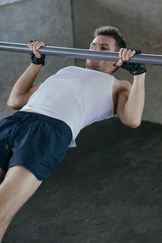 Stay Strong After 60: Bodyweight Strength Training for Seniors at Home 3 man performing bodyweight row on bar