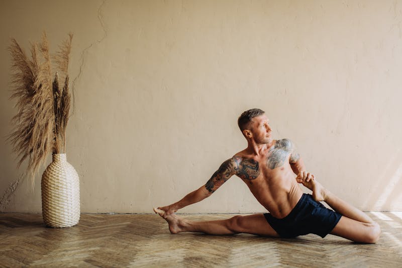 Strength Training Without Weights: 5 Powerful Minimalist Routines 4 man stretching while working out at home