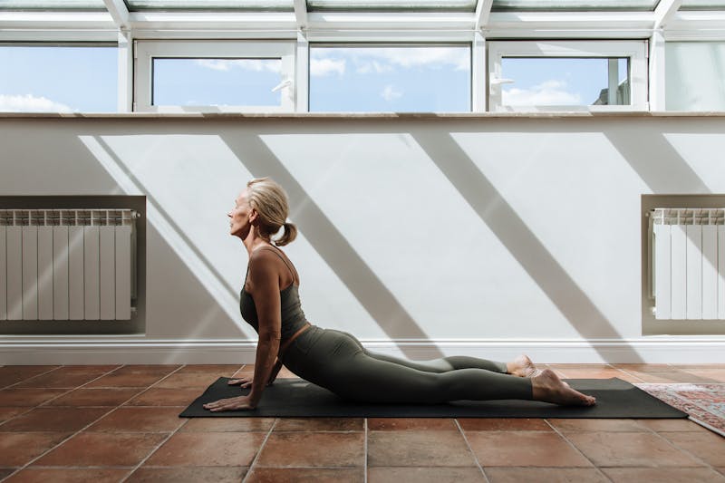 Strength Training for Seniors: 7 Powerful Ways to Stay Strong and Independent for Life 5 senior woman performing yoga at home